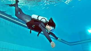 Female Diver is Diving with Neoprene Wetsuit in Pool