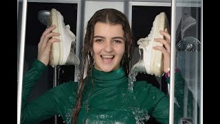 girl in an apartment gets her clothes wet in the shower