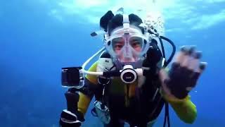 Female Presenter is Diving with Neoprene Wetsuit and Mantis Full Face Mask in Sea