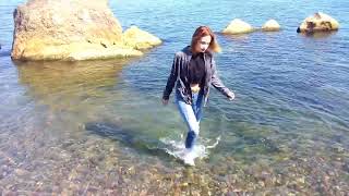 girl gets wet in clothes and swims in the sea