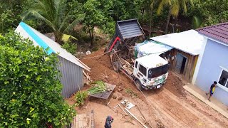 New Project actively working Small Bulldozer pushing soil In the corner of the house And dump truck