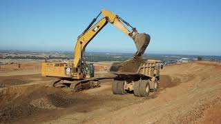 Cat 390F mass excavator loads out Cat 773G haul trucks in Folsom, CA