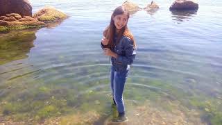 model in wet clothes in the sea