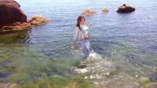 girl swimming in the sea in clothes