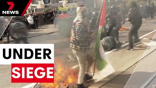 Wild scenes in Melbourne outside controversial weapons conference | 7NEWS