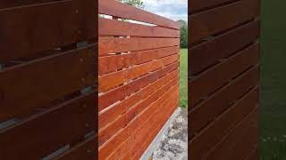 Wooden railings and storage space made of interlocking paving for dustbins