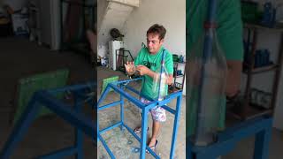 Man makes broom using recycled plastic bottles.