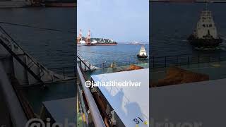 tug of war between a huge ship and tugboat