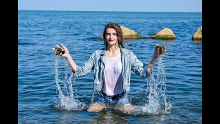 model in wet clothes swims in the sea