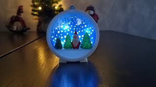 Assembling 3d printed colorful сhristmas ornament with light, trees, Santa Claus