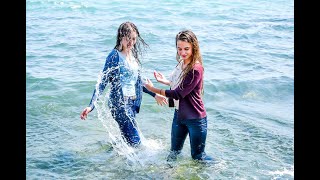 beautiful girls in wet clothes play in the water