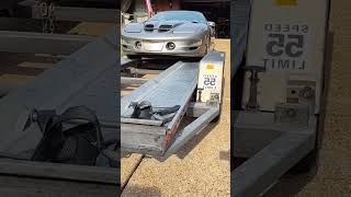 Pushing car on U-Haul trailer