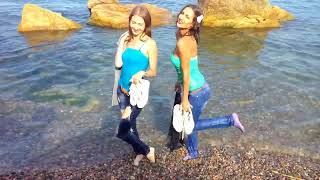 beautiful girls get wet in their clothes and play in the sea