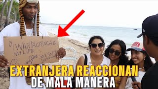 ESTE JOVEN IMPRESIONA A TODAS LAS GRINGA EN LA PLAYA CON UNA FRASES ESCRITA EN UN CARTÓN