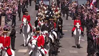 The newlyweds begin their carriage procession through Windsor, greeted by cheers from thousands