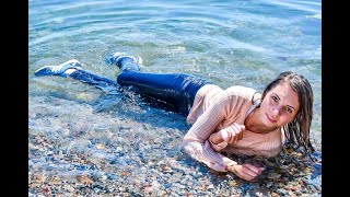 wetlook girl in wet clothes gets wet in the sea