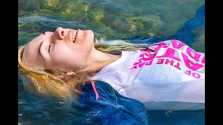 girl gets wet in jeans and a denim jacket in the sea