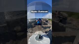 Spinning globe sculpture on the southern headland of Bondi Beach on a brilliant sunny morning.