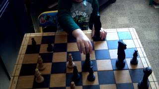 Noah enjoying playing  some  chess. Young buck