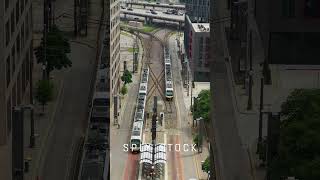 DART Trains passing each other in Downtown Dallas Texas 4K Aerial Drone Stock Footage