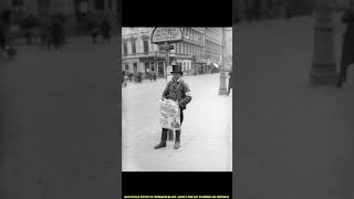 Historical photos grayscale photo of woman in black jacket and hat standing on sidewalk