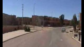 John Goldie driving through a Moroccan town