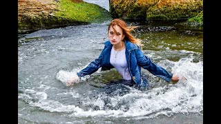 model gets wet in clothes and swims in the sea