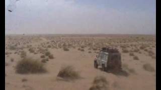 John Goldie being passed by a Land Rover 110 Defender