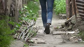 C0034 womans feet walking in alley