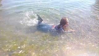 pretty girl gets wet in the sea playing with water