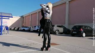 DANA LABO - the woman in black, glossy vinyl leggings, laced boots high heels, leather mini jacket 4