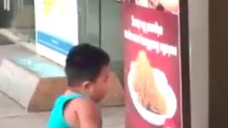 Little Boy Eats Pasta From a Poster