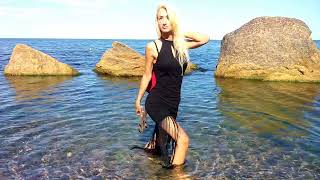 wetlook girl in a dress enters the water