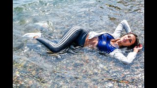 girl in sportswear gets wet in the sea