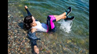 girl gets wet in a tracksuit in the sea