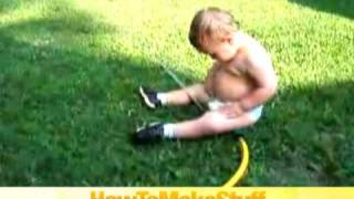 Baby Playing With The Sprinkler