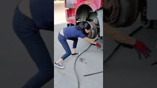 Truck Tire Changing By A Woman