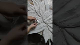 Magic lotus bas-relief flower. Process of sculpting flower relief work.