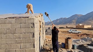 Love at its peak: Hussain and Jamila building the roof of their dream cottage