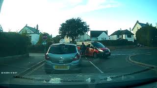 Taxi cuts corner and clips stationary cyclist