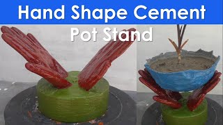 A hand shape stand holding a cement flower pots - garden - home decoration - cement craft ideas