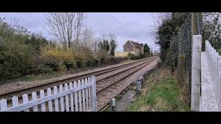 Class 317 passing Cranborne LC with a 2 tone horn.