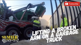 Lifting A Broken Arm On A Garbage Truck