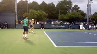 Leandar Paes swinging loosely during warm up at 2014 US Open