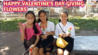 Happy Valentine's day giving flowers to strangers