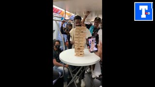 Group of friends plays Jenga on moving New York subway train